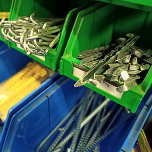 tent pegs in blue and green tote boxes