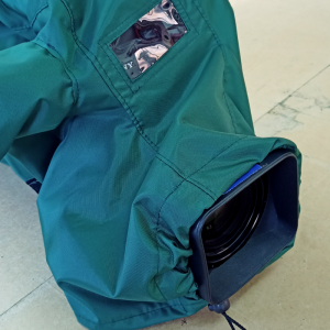 Fitted camera cover in green fabric showing the lens.