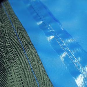 Blue fabric cover showing a zip and a waterproof seam.