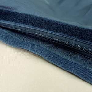 Image of a zip covered with a Velcro flap in black fabric